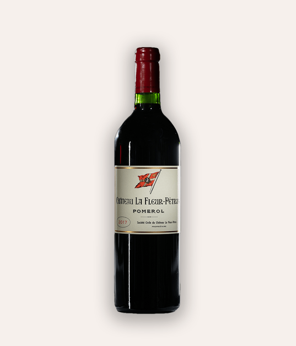 Weinflasche Château La Fleur-Pétrus 2017 Pomerol – dunkle Bordeaux-Flasche mit roter Kapsel, beiges Etikett mit roter Schiff-Flaggen-Illustration und Aufschrift Château La Fleur-Pétrus Pomerol 2017